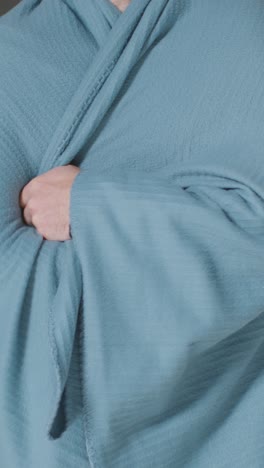 Vertical-Video-Close-Up-Of-Person-Wearing-Blanket-Trying-To-Keep-Warm-In-Energy-Crisis